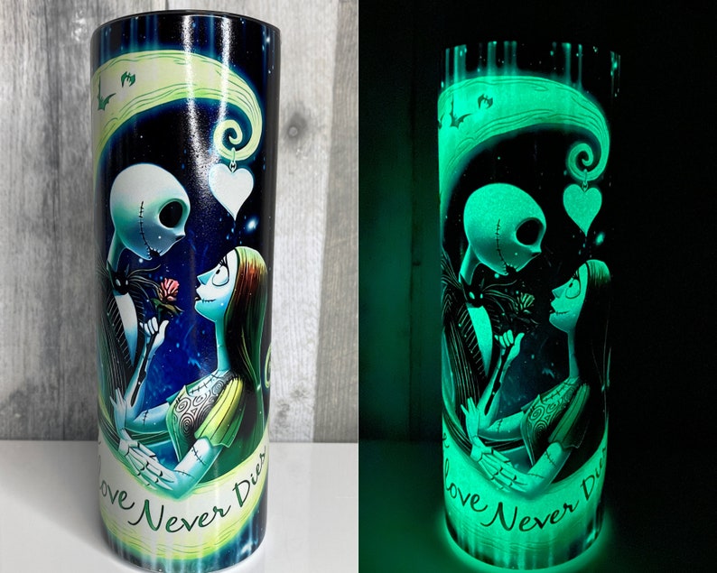 May include: A black and green glow-in-the-dark tumbler with a graphic of Jack Skellington and Sally from the Nightmare Before Christmas. The tumbler has the text "Love Never Dies" on it.