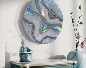 May include: A round, white and gray wall art piece with iridescent accents. The art piece is shaped like a geode and has a crystal-like texture.