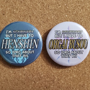 May include: Two round blue and white buttons with text. The blue button says "I'm nonbinary but I have to henshin so idrc about that rn". The white button says "I'm nonbinary but I have to ohgai busou so idrc about that rn".