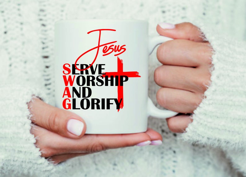 May include: White ceramic mug with a red cross and the words "Jesus", "Serve", "Worship", "And", and "Glorify" in black text.