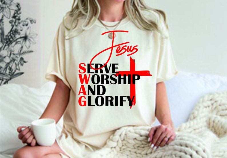 May include: A white t-shirt with a red cross and the text "Jesus Serve Worship And Glorify" printed on it.