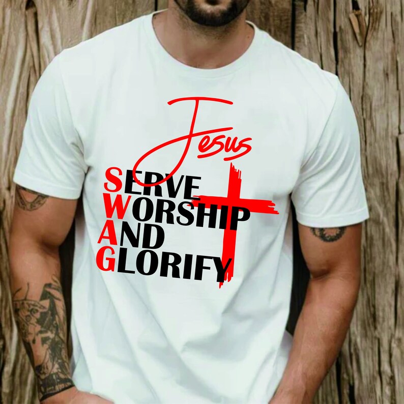 May include: White t-shirt with a red cross and the words "Jesus", "Serve", "Worship", "And", and "Glorify" printed on it.