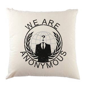 May include: A white throw pillow with a black and white graphic of the Anonymous logo. The logo features a person in a suit with a question mark for a head, a globe, and the text "WE ARE ANONYMOUS".