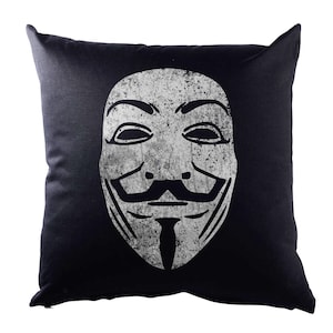 May include: A black cushion with a white graphic of the Anonymous mask. The mask has a stylised grin and a goatee.