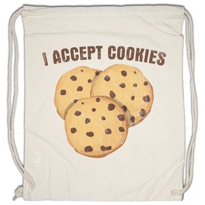 May include: Cream-coloured drawstring bag with the text "I ACCEPT COOKIES" in brown. The bag displays a graphic of three chocolate chip cookies. The cookies are light brown with dark brown chocolate chips.