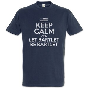 May include: Dark blue t-shirt featuring the white text "KEEP CALM and LET BARTLET BE BARTLET" and a small American flag. The shirt has a crew neck and short sleeves.