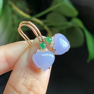 May include: A pair of heart-shaped lavender jade earrings with green jade accents and gold settings.