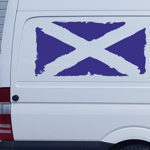 May include: A white van with a blue and white Scottish flag decal on the back.