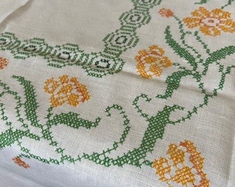 Lovely sunny white linen cross stitched tablecloth 74X56 with yellow and green florals. Made in England circa 1950. MINT condition.
