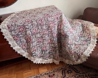 Christmas ROUND machine embroidered poly tablecloth. Garnet Red and Gold flowers with lace border. Pristine unused condition.