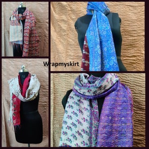 May include: Four different silk scarves with various patterns and colours. The scarves are made of kantha stitching, a traditional Indian embroidery technique. The scarves are displayed on mannequins.