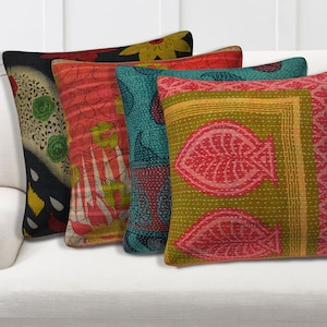 May include: Four decorative throw pillows with a variety of colorful patterns. The pillows feature floral, paisley, and geometric designs in shades of red, green, blue, and yellow. The pillows are made of a soft, quilted fabric and have a subtle sheen.