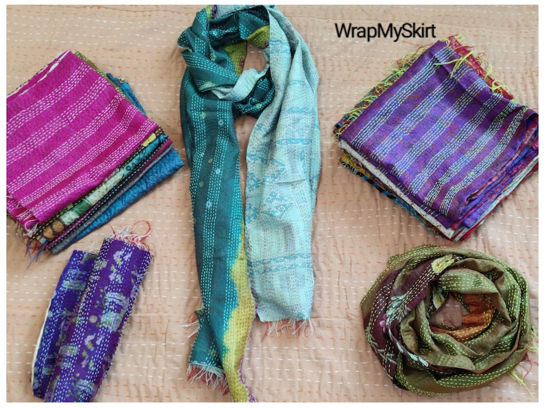 May include: Assortment of colorful kantha quilts and scarves in various patterns and colors, including teal, purple, pink, and brown. The text "WrapMySkirt" is visible in the top right corner of the image.