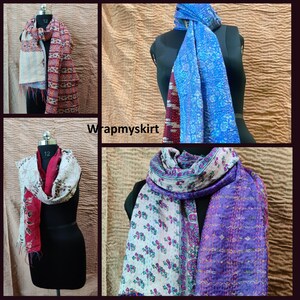 May include: Four different silk scarves with various patterns and colors. The scarves are made of kantha stitching, a traditional Indian embroidery technique. The scarves are displayed on mannequins.