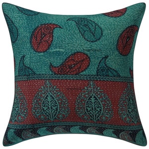 May include: Teal and burgundy paisley patterned throw pillow with a quilted design. The pillow has a decorative border with a paisley pattern.
