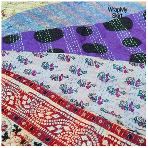 May include: A multi-colored patchwork fabric with a floral pattern, polka dots, and a geometric design. The fabric is stitched together with a running stitch. The text "WrapMy Skirt" is visible in the upper right corner of the image.