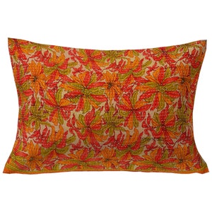 May include: A rectangular pillow with a floral pattern. The pillow is made of a soft, cotton fabric and features a beige background with orange, red, and green flowers. The pillow is perfect for adding a touch of color and style to any room.