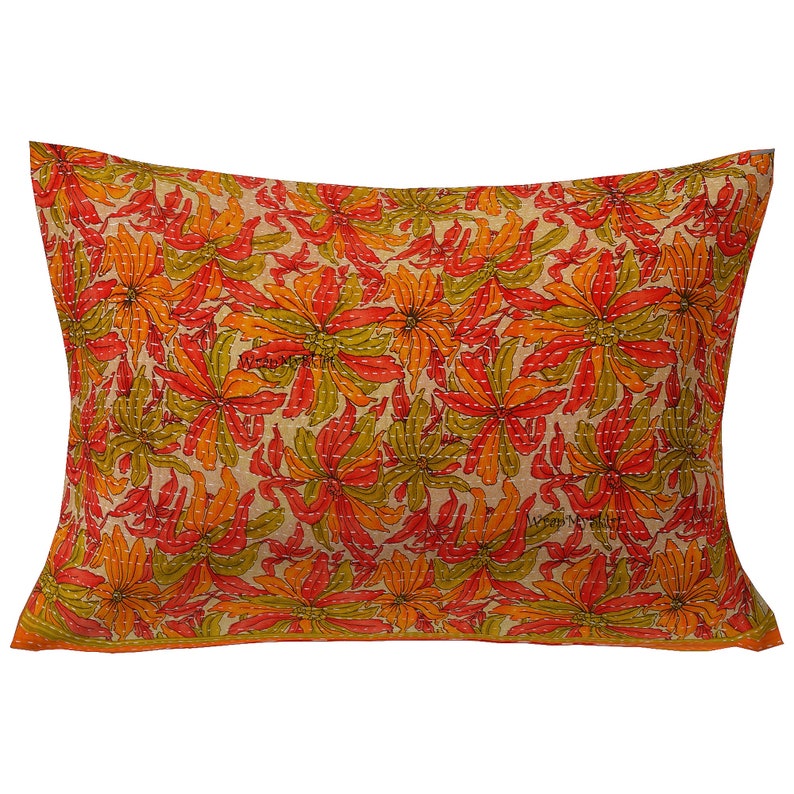 May include: A rectangular pillow with a floral pattern. The pillow is made of a soft, cotton fabric and features a beige background with orange, red, and green flowers. The pillow is perfect for adding a touch of color and style to any room.