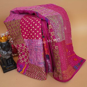 Pu&ograve; includere: Una trapunta kantha rosa e oro con un design a patchwork. La trapunta &egrave; realizzata con sari riciclati e presenta una variet&agrave; di motivi, tra cui pois, paisley e motivi floreali.