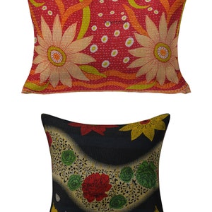 May include: Two decorative throw pillows with floral patterns. The larger pillow is red with white and yellow flowers. The smaller pillow is black with red, yellow, and green flowers.