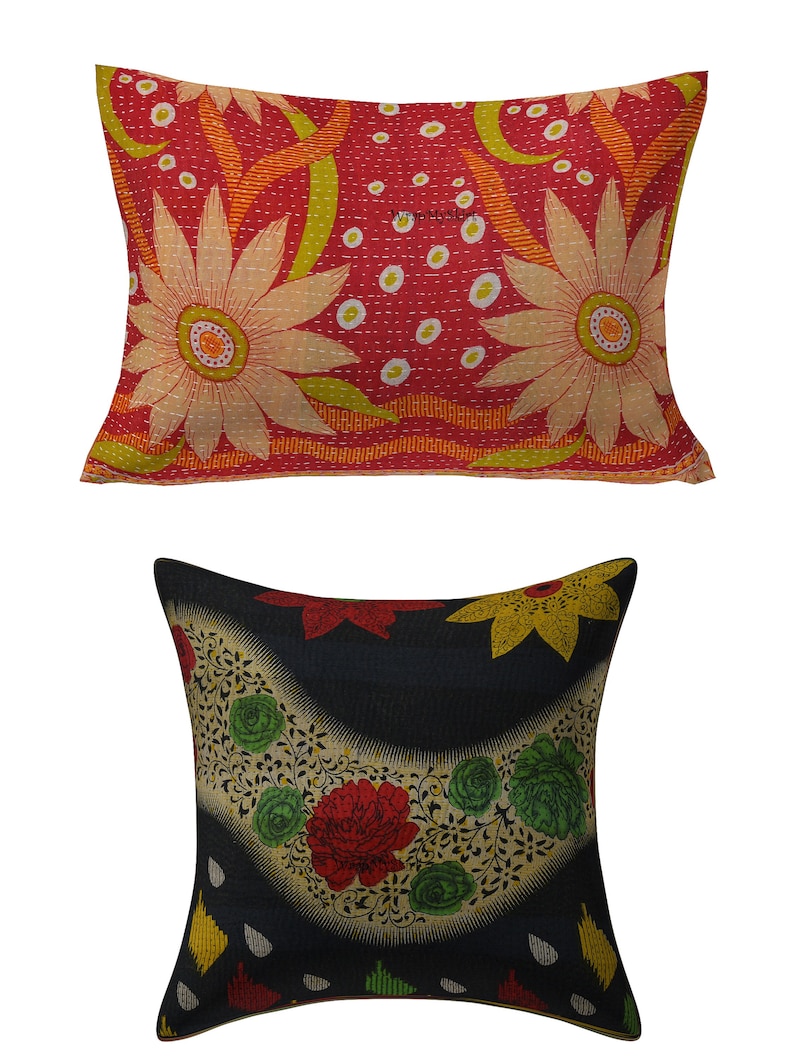 May include: Two decorative throw pillows with floral patterns. The larger pillow is red with white and yellow flowers. The smaller pillow is black with red, yellow, and green flowers.