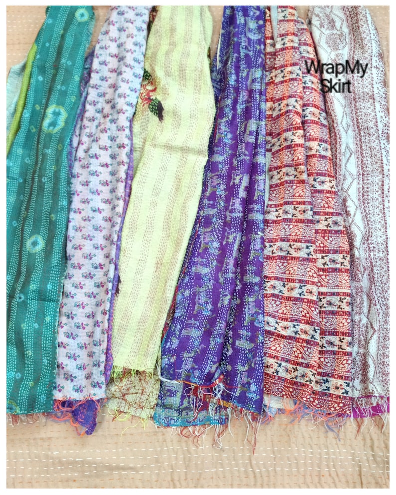 May include: A collection of seven colorful kantha quilts with various patterns and designs. The quilts are made of recycled saris and are perfect for adding a touch of bohemian style to any room.