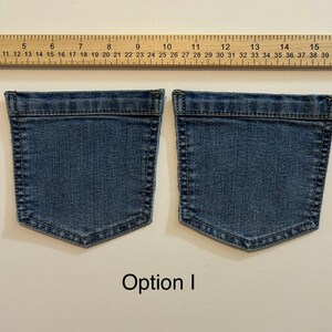 Pode incluir: Dois bolsos de ganga azul-m&eacute;dia, com uma r&eacute;gua por cima. Os bolsos t&ecirc;m formato retangular. O texto "Option I" est&aacute; em baixo.