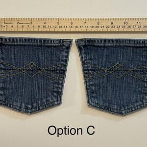 Pode incluir: Dois bolsos de cal&ccedil;as de ganga azuis com costuras amarelas e um design decorativo. Uma r&eacute;gua de madeira com medidas em polegadas est&aacute; acima dos bolsos. O texto "Op&ccedil;&atilde;o C" est&aacute; abaixo.