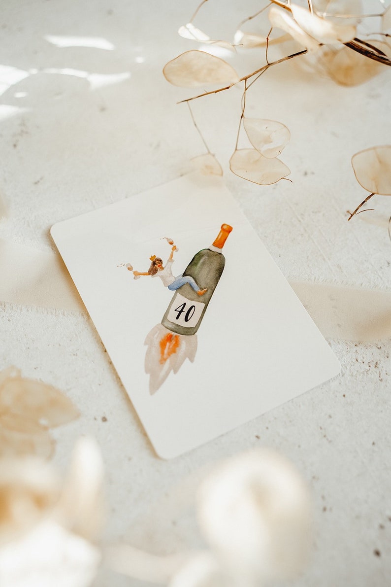 May include: A watercolor illustration of a person riding a wine bottle shaped like a rocket, with the number 40 on the side. The person is wearing a crown and holding a glass of wine.