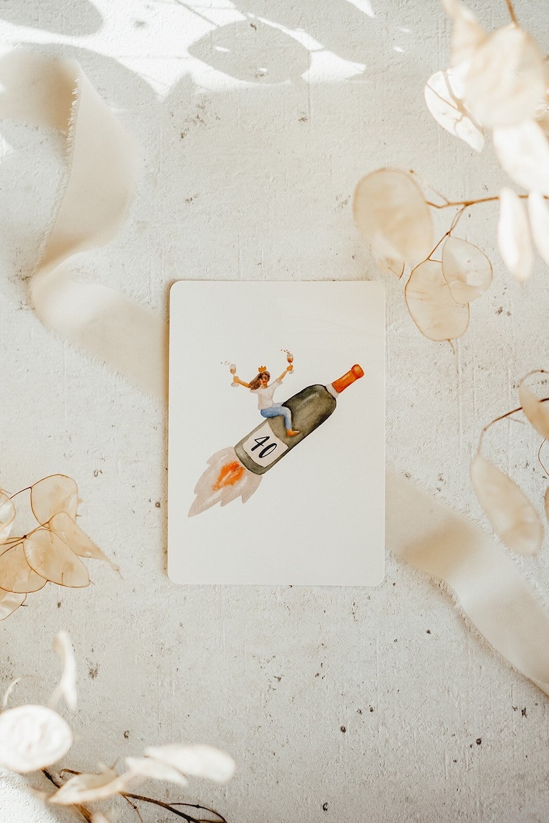 May include: A watercolor illustration of a person wearing a crown and holding two glasses of wine, riding on a wine bottle shaped like a rocket with the number 40 on the side.