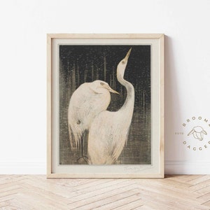 May include: A framed print of a Japanese woodblock print depicting two white herons in a dark forest setting.