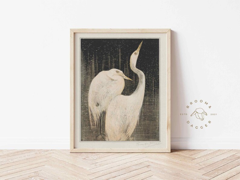 May include: A framed print of a Japanese woodblock print depicting two white herons in a dark forest setting.