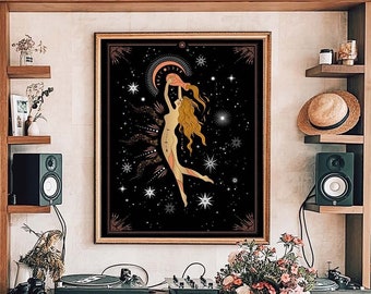 May include: A framed print of a woman dancing with a crescent moon and stars in the background. The print has a black background with gold accents and is framed in a dark wood frame.