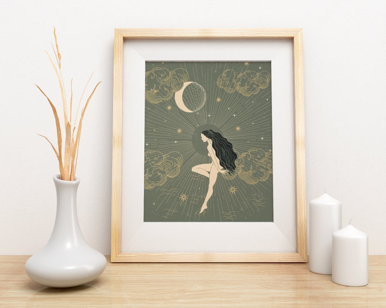 May include: A framed print with a green background featuring a woman with long black hair sitting on a cloud with a crescent moon and stars in the background.