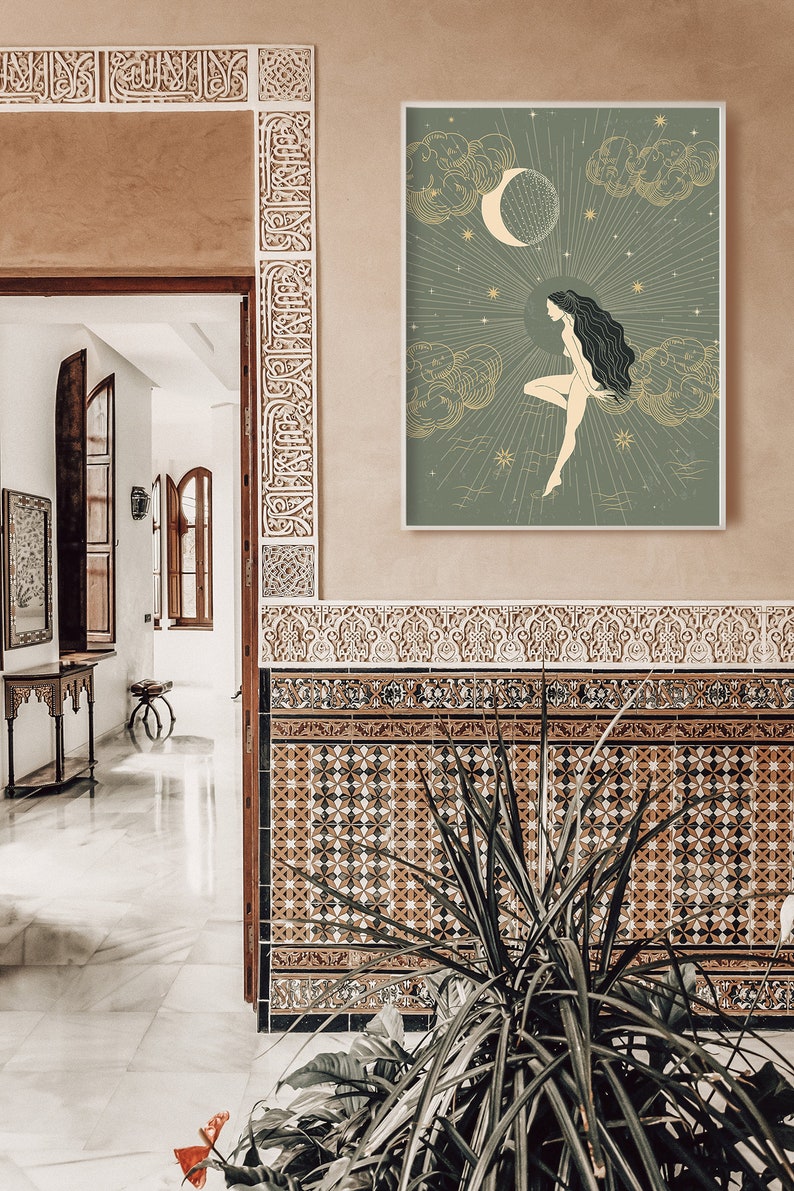 May include: A green and gold illustration of a woman standing on a cloud with a crescent moon and stars in the background. The illustration is framed and hanging on a wall with brown and white patterned tiles.