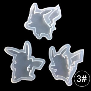 May include: Three clear silicone molds in the shape of Pikachu, a popular cartoon character. The molds are arranged against a black background. One mold has the number "3#" in a white circle.
