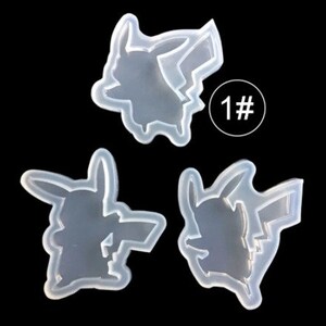 May include: Three clear silicone molds in the shape of Pikachu, a popular cartoon character. The molds are arranged on a black background. One mold has the number "1#" in a white circle.