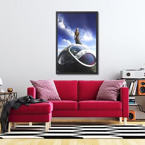 May include: A framed print of a woman standing on a large, metallic sphere. The woman is wearing a long, flowing dress and has her back to the viewer. The sphere is surrounded by clouds and a blue sky.