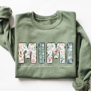 May include: Green sweatshirt with the word "MIMI" in floral print letters. Below the word is the text "Chloe ♥ Madison ♥ James".