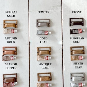 Amaco Rub’n buff rub’nbuff rub ‘n buff tubes of wax paint used for antiquing, gilding, arts and crafts and DIY projects at home. Metallic paint in Grecian gold, pewter, Ebony, autumn gold, gold leaf, European gold, Spanish copper, antique gold