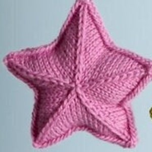 May include: Three knitted star ornaments in pink, green, and blue hanging from white string.