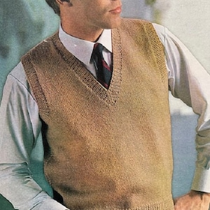 May include: A tan knitted vest with a V-neck. The vest is worn over a white collared shirt and a patterned tie. The knitted vest has a ribbed hem and armholes. The image is a vintage style.