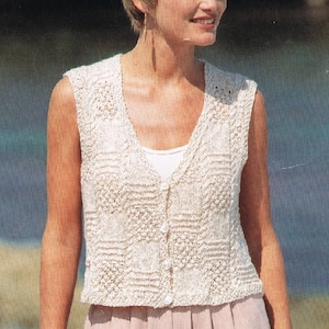 May include: A white crocheted sleeveless vest with a V-neck and button closure.