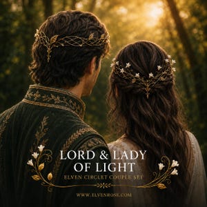 May include: A pair of gold-toned metal circlets featuring intricate wirework, leaf motifs, and small white floral accents. The text reads LORD & LADY OF LIGHT ELVEN CIRCLET COUPLE SET WWW.ELVENROSE.COM. The headpieces are worn by two individuals.