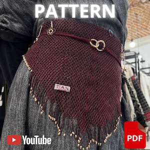 Puede incluir: Un chal de red burdeos con detalles y flecos dorados. La palabra "PATTERN" se muestra en la parte superior. El chal está adornado con cuentas doradas y una pequeña etiqueta rectangular. Los logotipos de YouTube y PDF son visibles.