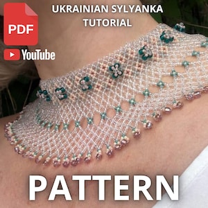 May include: A beaded necklace with a delicate, openwork design. The necklace features clear beads, accented with small green and pink floral elements. The text "UKRAINIAN SYLYANKA TUTORIAL" and "PATTERN" are visible.