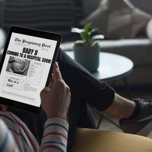 Op de afbeelding: Een persoon leest een zwart-witte krant op een tablet. De kop luidt "BABY D COMING TO A HOSPITAL SOON!" met een foto van een zwangere vrouw. De tekst onder de kop vraagt "Boy or a Girl?"