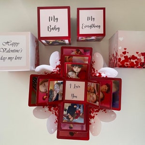 May include: A red and white explosion box with photos and the text "Happy Valentine's Day my love", "My Baby", "My Everything", and "I Love You".