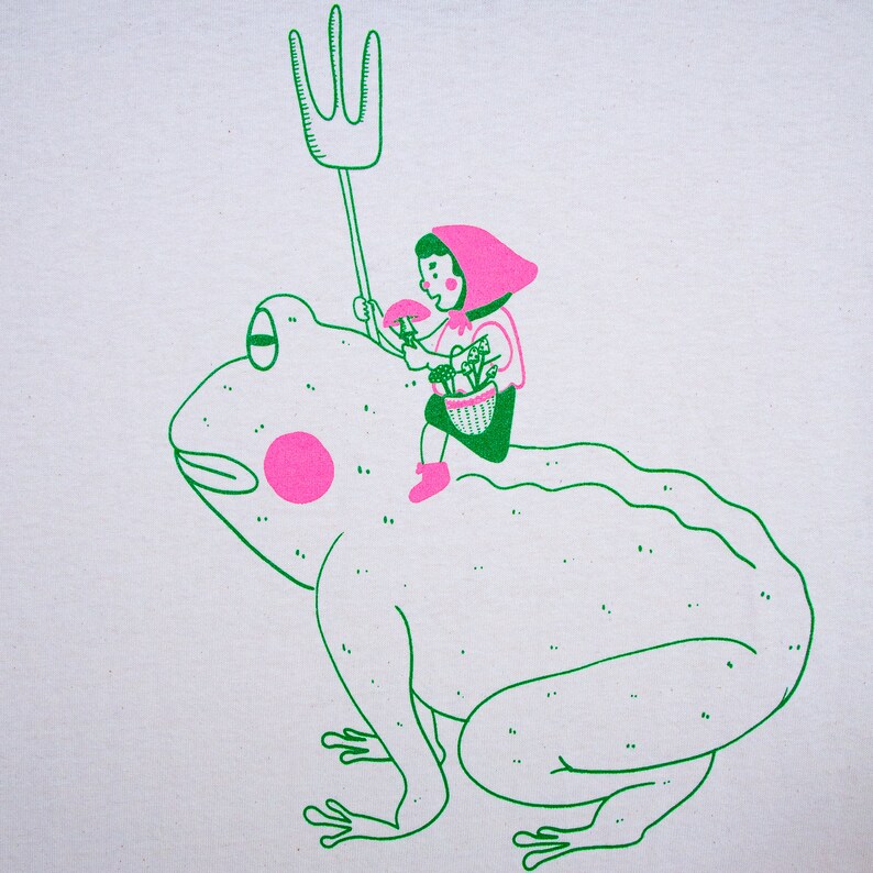 May include: A quirky illustration featuring a child riding a large frog. The child, dressed in pink, carries a mushroom and a basket of flowers. The frog is green with pink spots, and the child holds a green pitchfork. The design is on a white background.