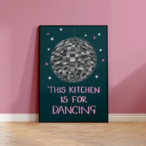 May include: A teal poster with a silver disco ball hanging from the ceiling. The poster has white and pink stars and the text "This kitchen is for dancing" in pink.